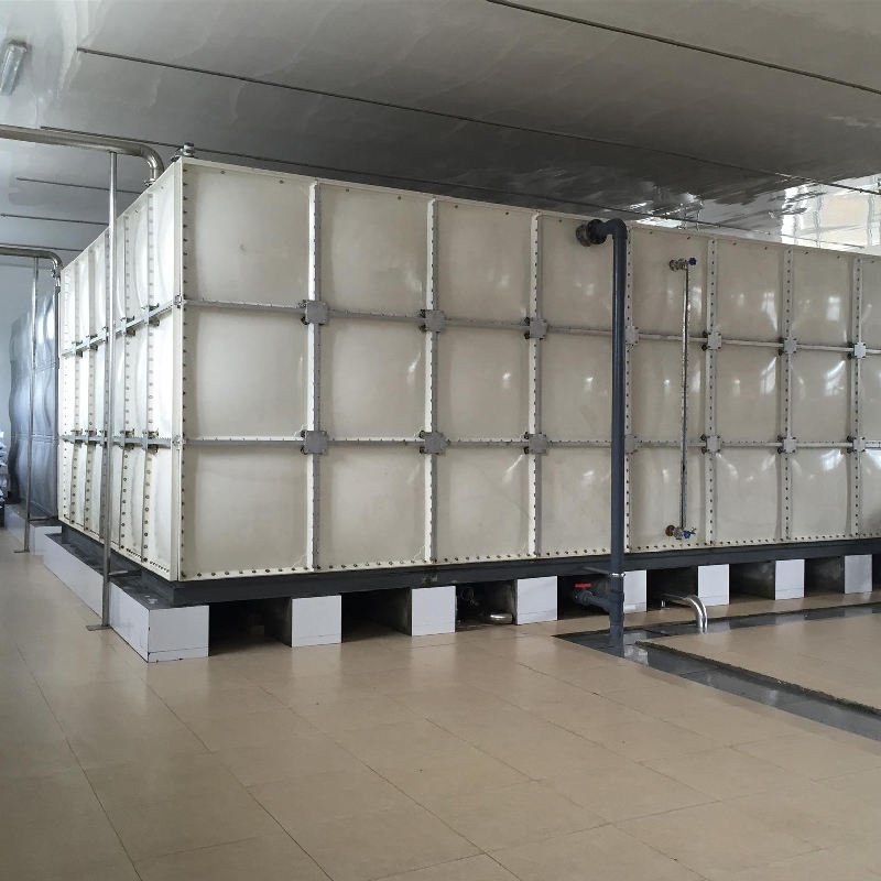 Stainless steel insulated storage tanks with piping at industrial facility