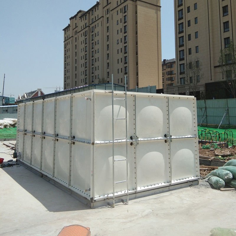 Industrial water storage tanks with insulated panels and pipe connections at a water treatment facility